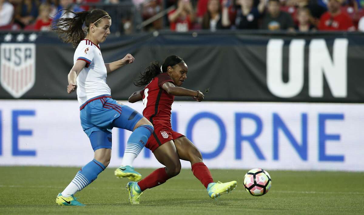FRISCO, TX - APRIL 06: Crystal Dunn #19 of the U.S. shoots and scores as Daria Makarenko #8 of Russia defends during the first half of the International Friendly soccer match at Toyota Stadium on April 6, 2017 in Frisco, Texas. (Photo by Mike Stone/Getty Images)