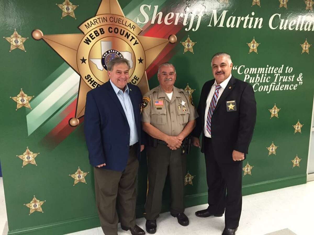 Sheriff Martin Cuellar, right, and Sheriff’s Office Chief Fred Garza, left, pose for a photo with deputy Antonio Sanchez.
