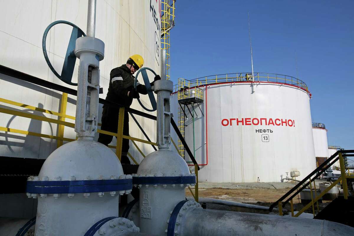 A worker turns a flow valve near oil storage tanks at a pumping station in the Samotlor oil field near Nizhnevartovsk, Russia. Russia’s deal with OPEC to cut crude supply hasn’t delivered as much as expected, according to Deputy Prime Minister Arkady Dvorkovich. OPEC ministers will gather in Vienna on May 25 to decide whether to extend the accord.
