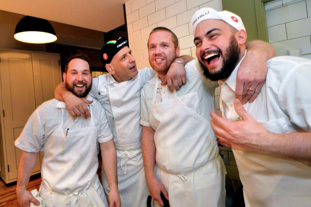 Chef de cuisine Matt Arcomone, Executive Chef Marc Vetri, Culinary Director Brad Spence and Chef de cuisine Drew DiTomo enjoy a few laughs during a soft opening of the new Amis restaurant in Bedford Square on March 30 in Westport.