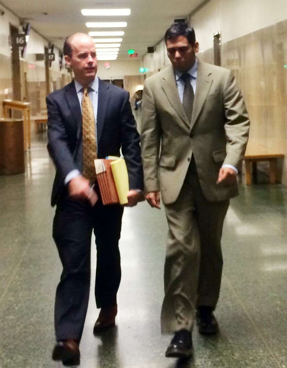 Enrique Pearce walks into court Friday alongside attorney, Sam O'Keefe.