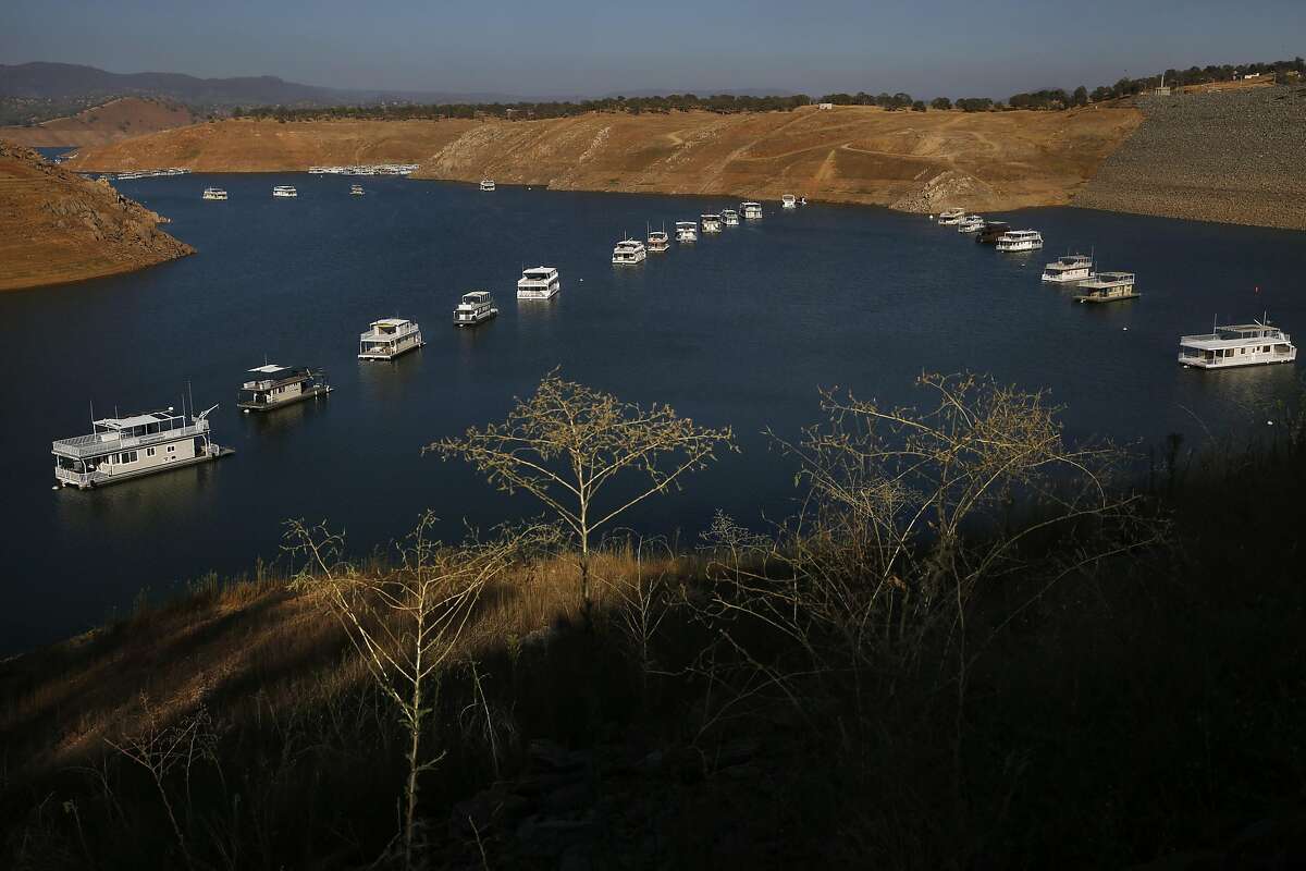 Houseboats float silently as the sun sets at Don Pedro Reservoir in 2015 during California’s last drought.