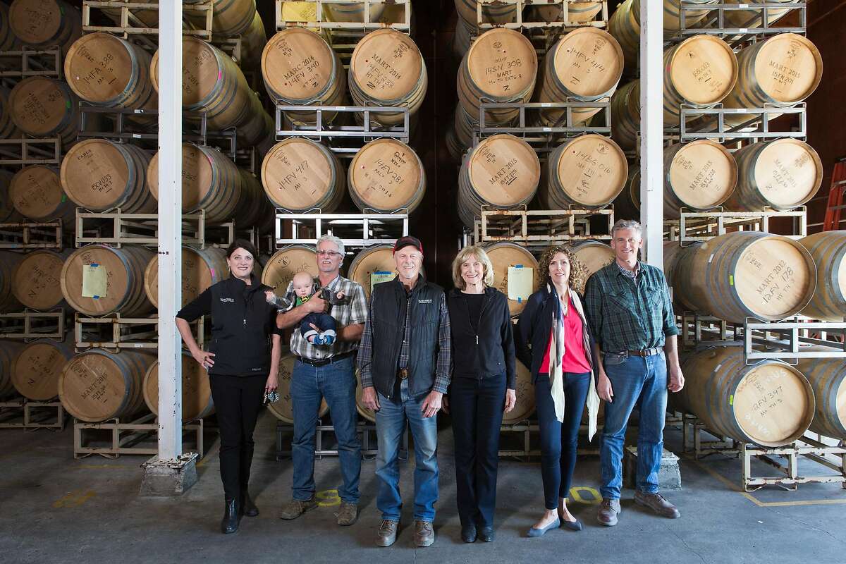 Julie Martinelli, Lee Jr Martinelli, holding Bondi Gorsuch, Lee Sr. Martinelli, Carolyn Martinelli, Regina Martinelli, and George Martinelli posing at the family run winery.