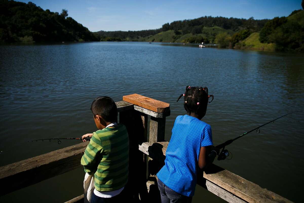 Marco David, 8, left, and Marietou Keita, 7 fish on the docks at Lake Chabot in Castro Valley, Calif. Saturday, April 1, 2017. Kids and families at UCSF Children's Hospital in Oakland are getting a nature prescription as part of a program to encourage kids to go outside to improve their health.