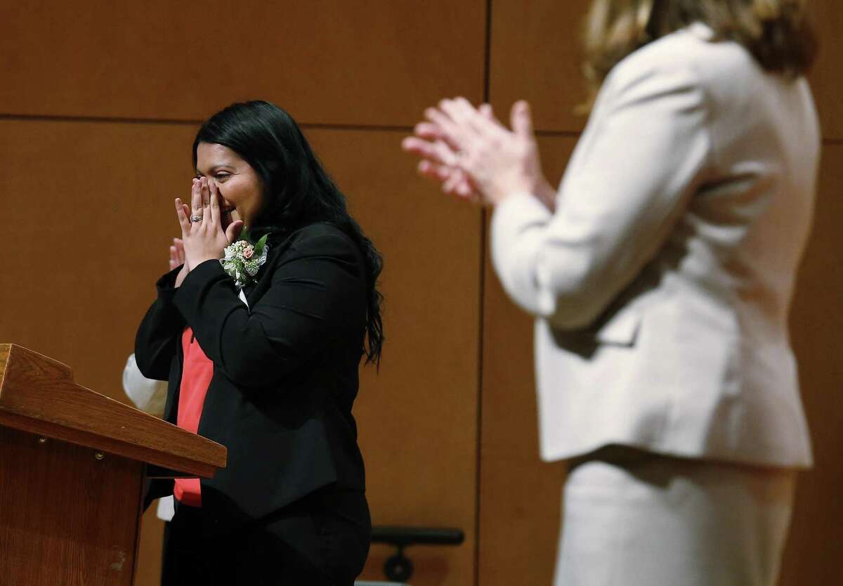 Educators Gloria Galvan of South San Antonio ISD (left) reacts to applause after she along with Ali Golfjahmofrad of North East ISD were awarded the Trinity Prize at Trinity University for their excellence in education on Friday, Apr. 7, 2017. Since 1982, Trinity University has honored local educators for their selfless and often unheralded work toward providing students with inspiration and a passion to succeed in school. This year, 19 educators were recognized with distinguished educators awards and Galvan and Goljahmofrad were selected for the Trinity Prize amongst their recognized peers. Galvan is a fifth-grade bilingual teacher at Price Elementary. Goljahmofrad is a quantitative reasoning teacher and coach at Theodore Roosevelt High School. (Kin Man Hui/San Antonio Express-News)