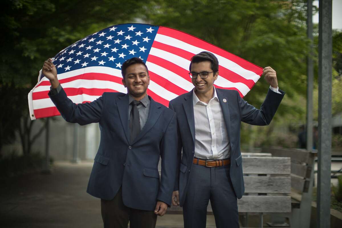 Pranav Jandhyala, 19, co-founded BridgeCal, a group seeking to bridge the political/ideological divide on campus and Naweed Tahmas, 20, is a member of the Berkeley College Republicans hold an American flag on Friday, April 7, 2017 in Berkeley, Calif. They have invited ultra-conservative Ann Coulter to campus -- but Pranav is encouraging students with opposing views to attend and ask challenging questions.