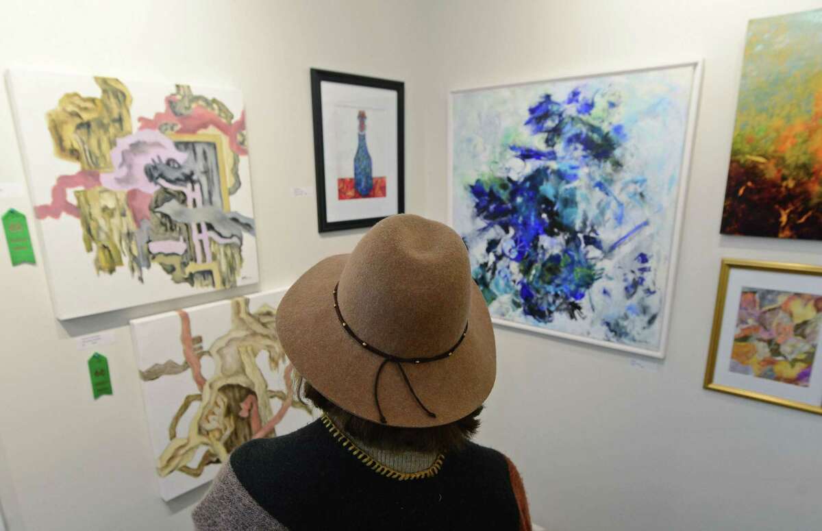 Anna Badini looks over abstract paintings as The Norwalk Arts Commission, in partnership with the Rowayton Arts Center hosts this year?’s SLOW Art Day program on Saturday, April 8, 2017, at the Rowayton Arts Center in Norwalk, Conn. Riad Miah, an award-winning New York artist and educator, led participants in a conversation about artwork he judged for RAC?’s Abstraction ?– Abstracts exhibit. The international program has grown from 16 museums and galleries in 2009 to more than 190 worldwide in 2016.