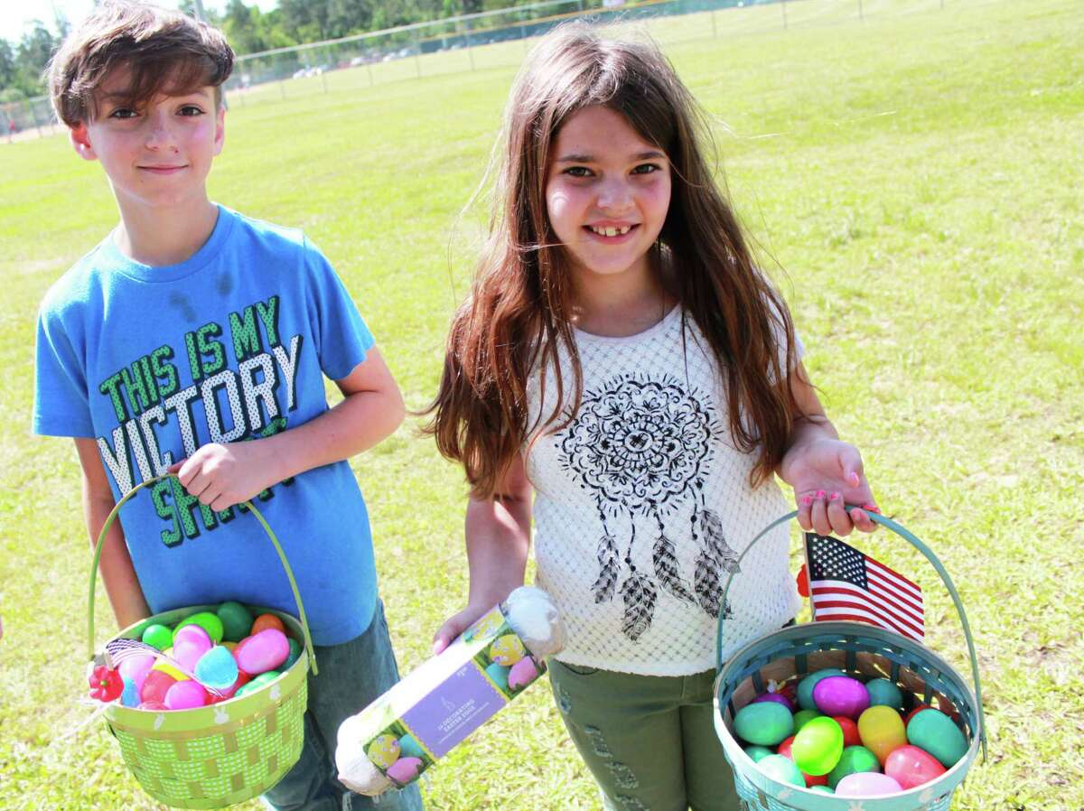 Siblings Caedin, 10, and Saedi Cleveland, 8, participated in the hunt for 18,000 color eggs hidden in the Carl Barton Jr. Softball Fields of Conroe Saturday at the annual Morning with Mr. Bunny.