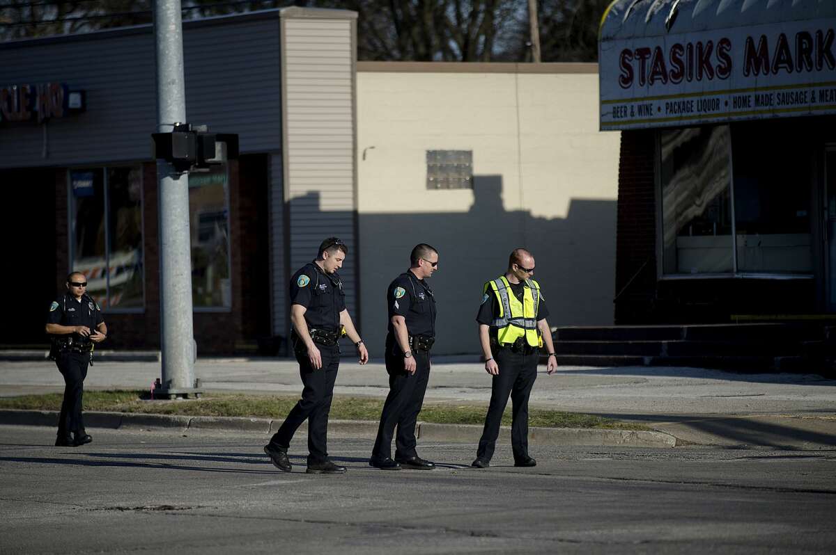 Midland police investigate the scene of a motorized scooter and car accident at the intersection of Bay City Road and Waldo Avenue on Saturday in Midland. Bay City Road at Waldo Avenue remained closed during the investigation.