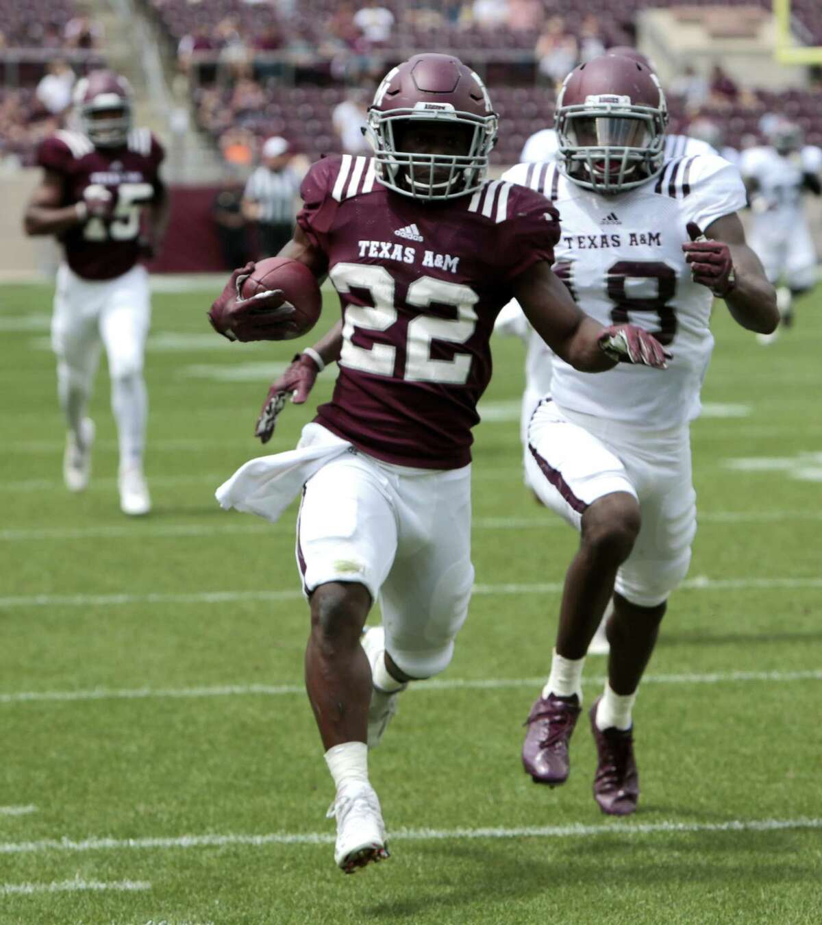 Texas A&M running back Kwame Etwi (22) breaks away from defensive back Kemah Siverand (18) on a long gain up the sidelines during the Texas A&M spring football game at Kyle Field on Saturday, April 8, 2017, in College Station. ( Brett Coomer / Houston Chronicle )
