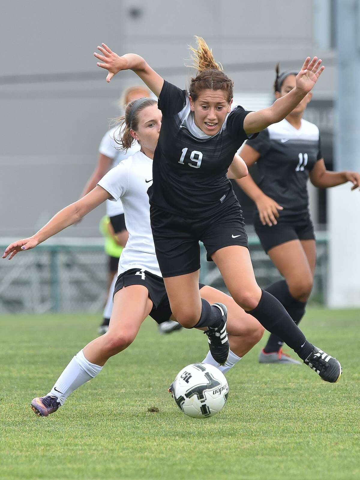 Steele's Andrea Cardenas (19) and Vandegrift's Holly Steber battle for control of the ball during the Region IV-6A girls soccer tournamnt Saturday at the Blossom Athletic Center.