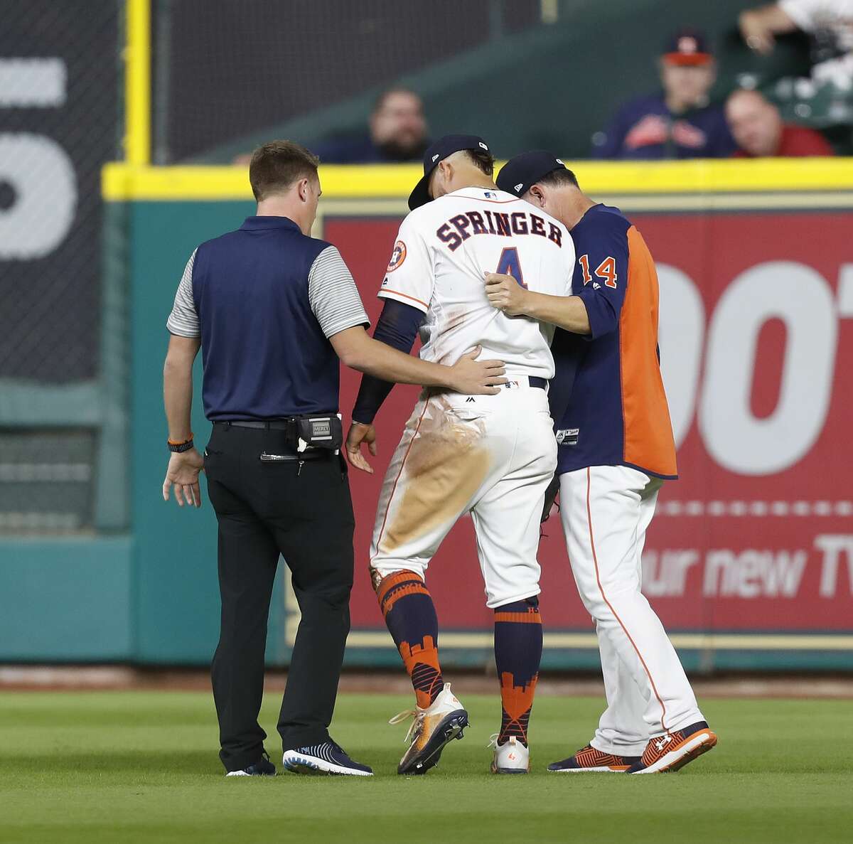 Houston Astros right fielder George Springer (4) is attended to after getting roughed up chasing Kansas City Royals Paulo Orlando's foul ball during the eighth inning of an MLB baseball game at Minute Maid Park, Saturday, April 8, 2017, in Houston. ( Karen Warren / Houston Chronicle )