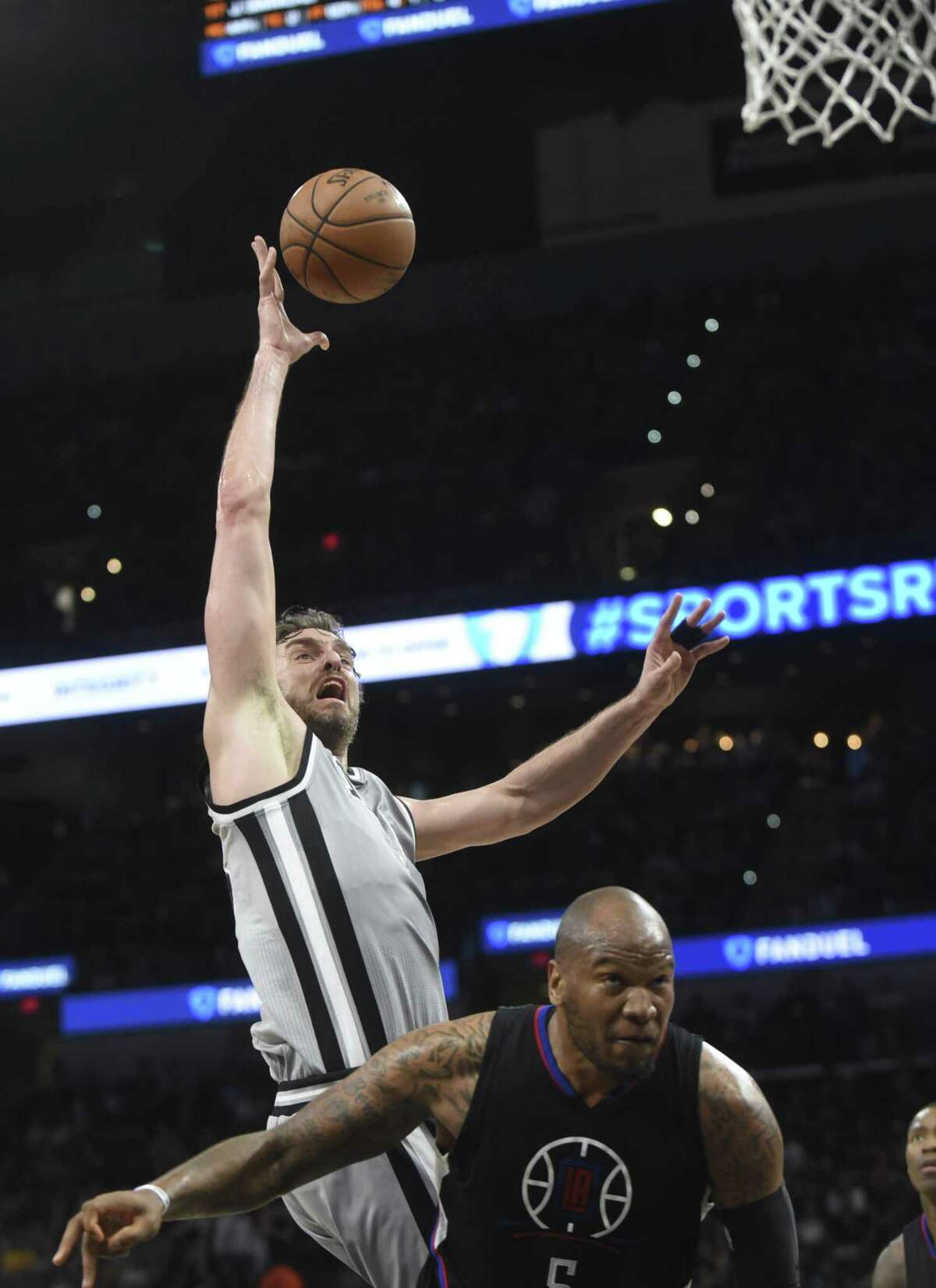 Pau Gasol of the San Antonio Spurs shoots over Marreese Speights of the Los Angeles Clippers during first-half NBA action at the AT&T Center on April 8, 2017.