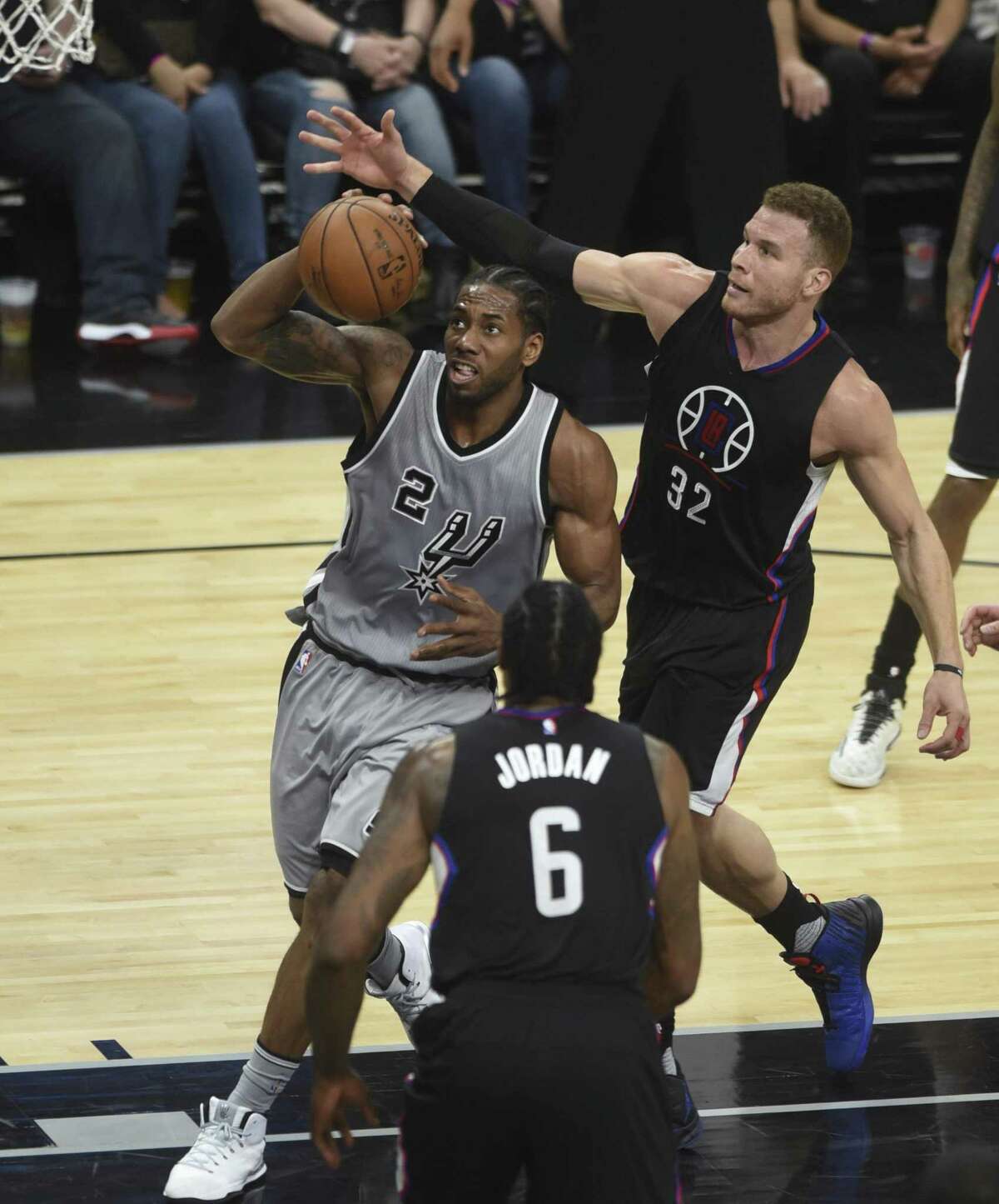 Kawhi Leonard of the Spurs is pursued by Blake Griffin of the Los Angeles Clippers during second-half NBA action at the AT&T Center on Saturday, April 8, 2017.