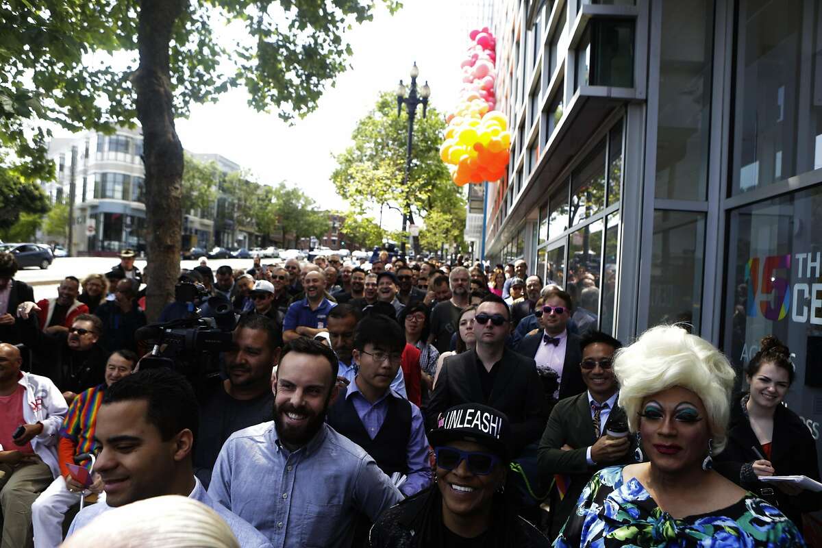 People gather to watch the speakers on stage at the reopening of the LGBT Center on Sunday, April 9, 2017, in San Francisco, Calif.