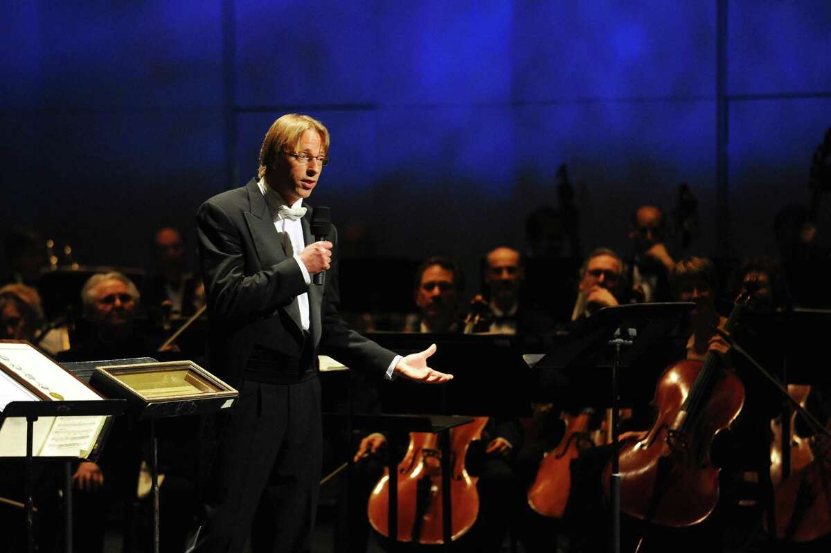 Stamford Symphony musical director and conductor Eckart Preu speaks to the audience before his final concert "Northern Lights" inside the Palace Theater in Stamford, Conn. on Sunday, April 9, 2017.