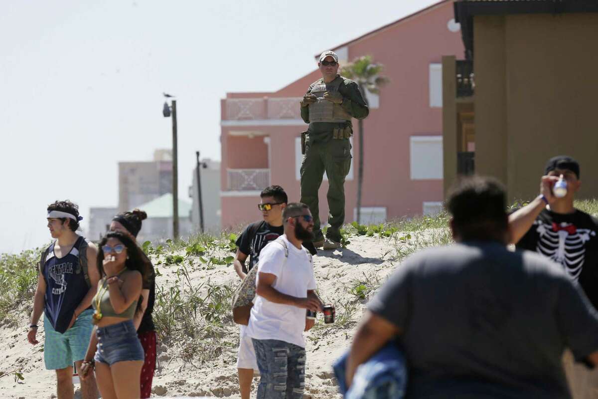 Law enforcement agents from federal to local levels keep an eye on the crowd at Clayton's Beach Bar and Grill in South Padre Island, Tuesday, March 14, 2017. Spring Break brings thousands of visitors to the island and last year, sales revenues grossed $30.5 million.