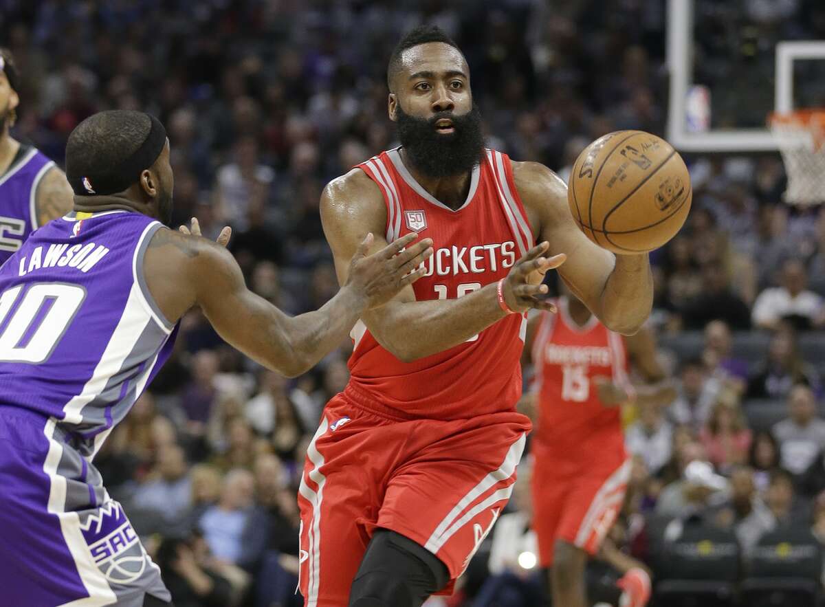 Houston Rockets guard James Harden, right, passes against Sacramento Kings guard Ty Lawson during the first half of an NBA basketball game, Sunday, April 9, 2017, in Sacramento, Calif. (AP Photo/Rich Pedroncelli)