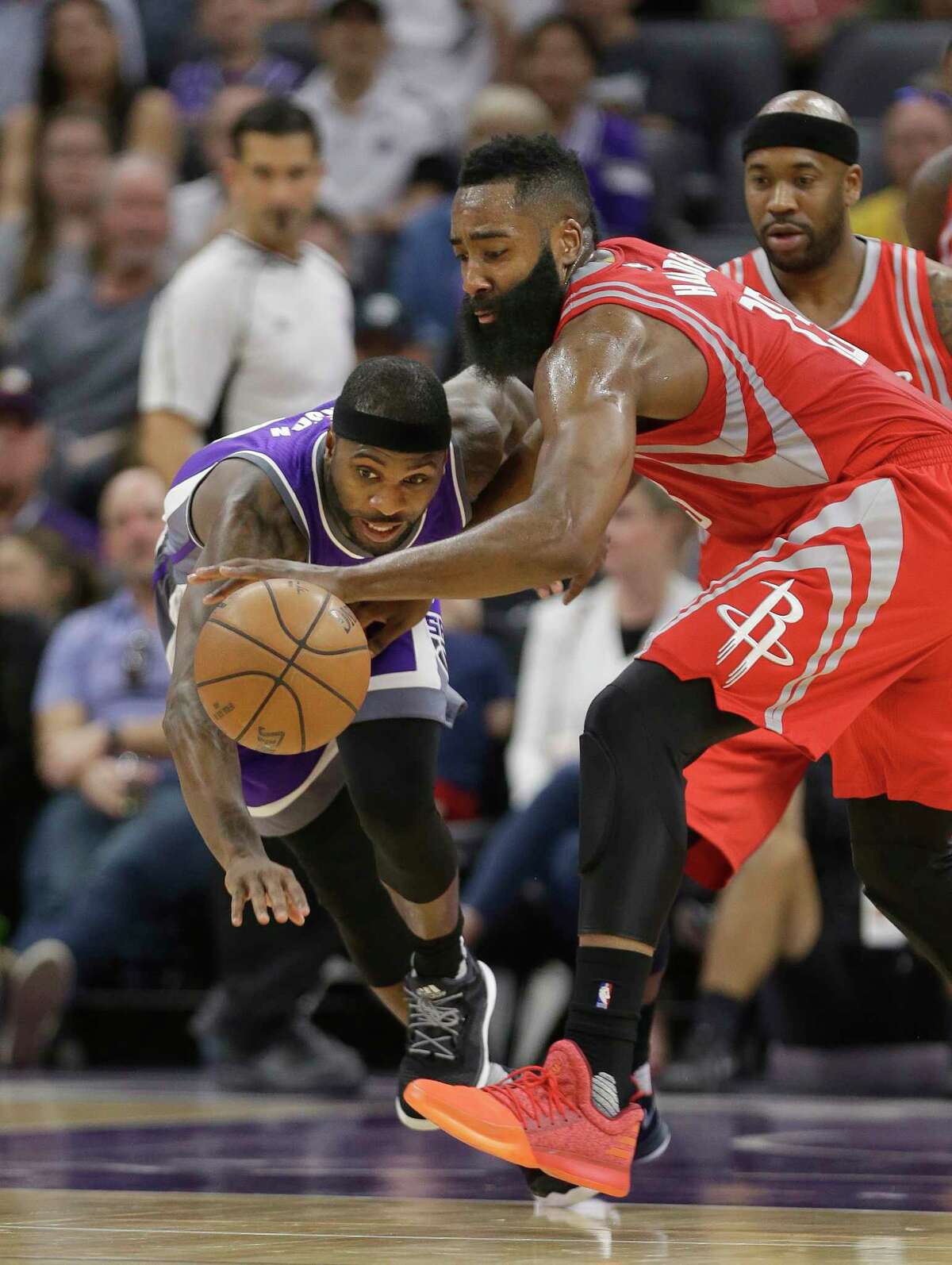 Sacramento Kings guard Ty Lawson, left, and Houston Rockets guard James Harden scramble for the ball during the first half of an NBA basketball game Sunday, April 9, 2017, in Sacramento, Calif. (AP Photo/Rich Pedroncelli)