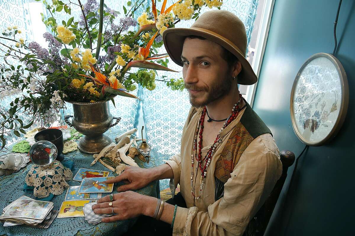 Hangedman Company owner Matthew Drewry reads tarot cards and is a wild floral arranger at MacArthur Annex, a retail complex of 24 shipping containers on Wednesday April 5, 2017, in Oakland, Calif.