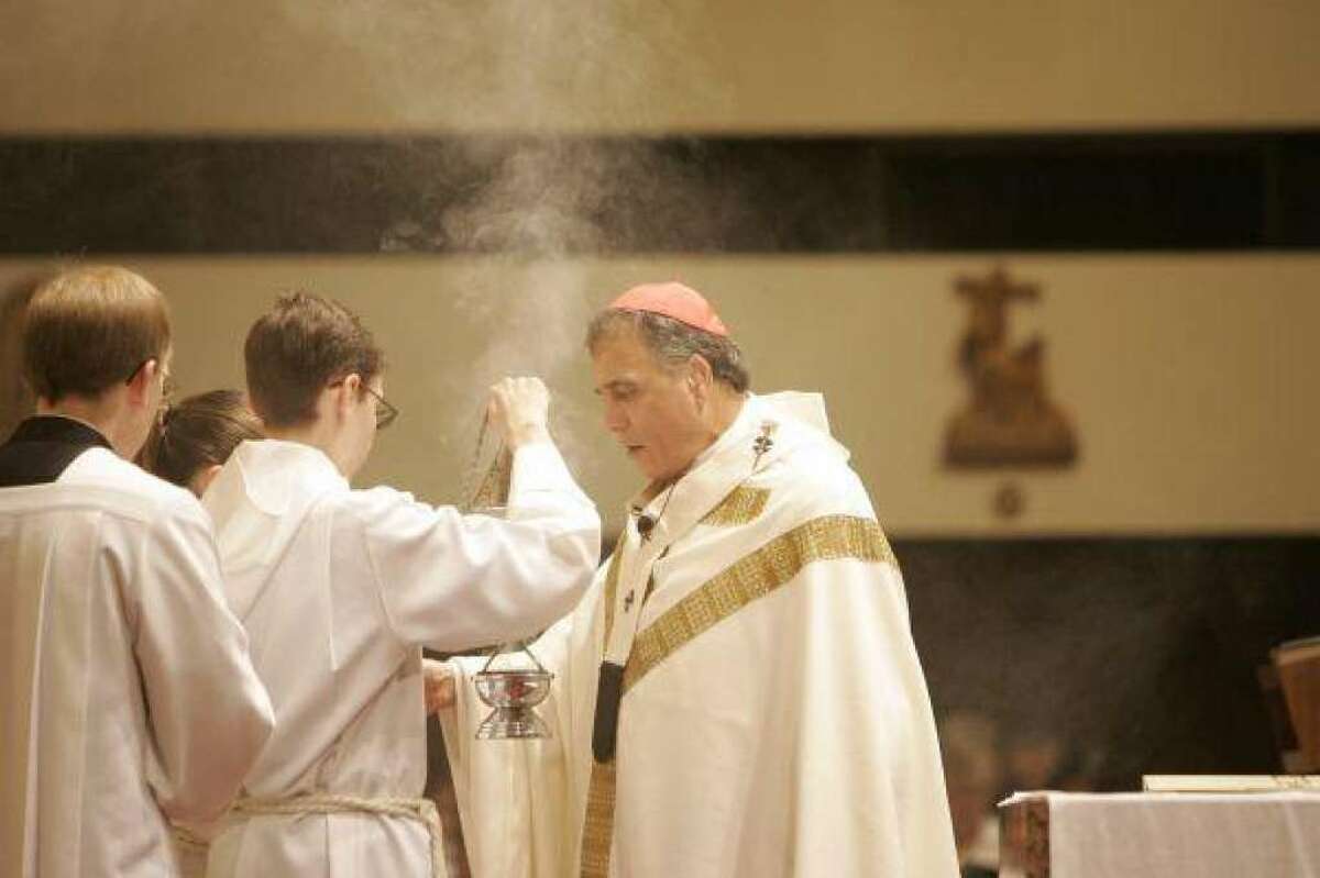 Cardinal Daniel DiNardo offering a blessing at a Mass of Thanksgiving during Sacred Heart Catholic School's 50th anniversary celebration in September 2008.