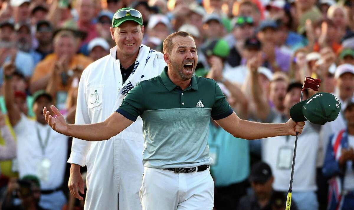 Sergio Garcia celebrates winning the Masters on April 9, 2017 at Augusta National Golf Club. Garcia defeated Justin Rose in a playoff. Looking on is Garcia’s caddie, Glen Murray.