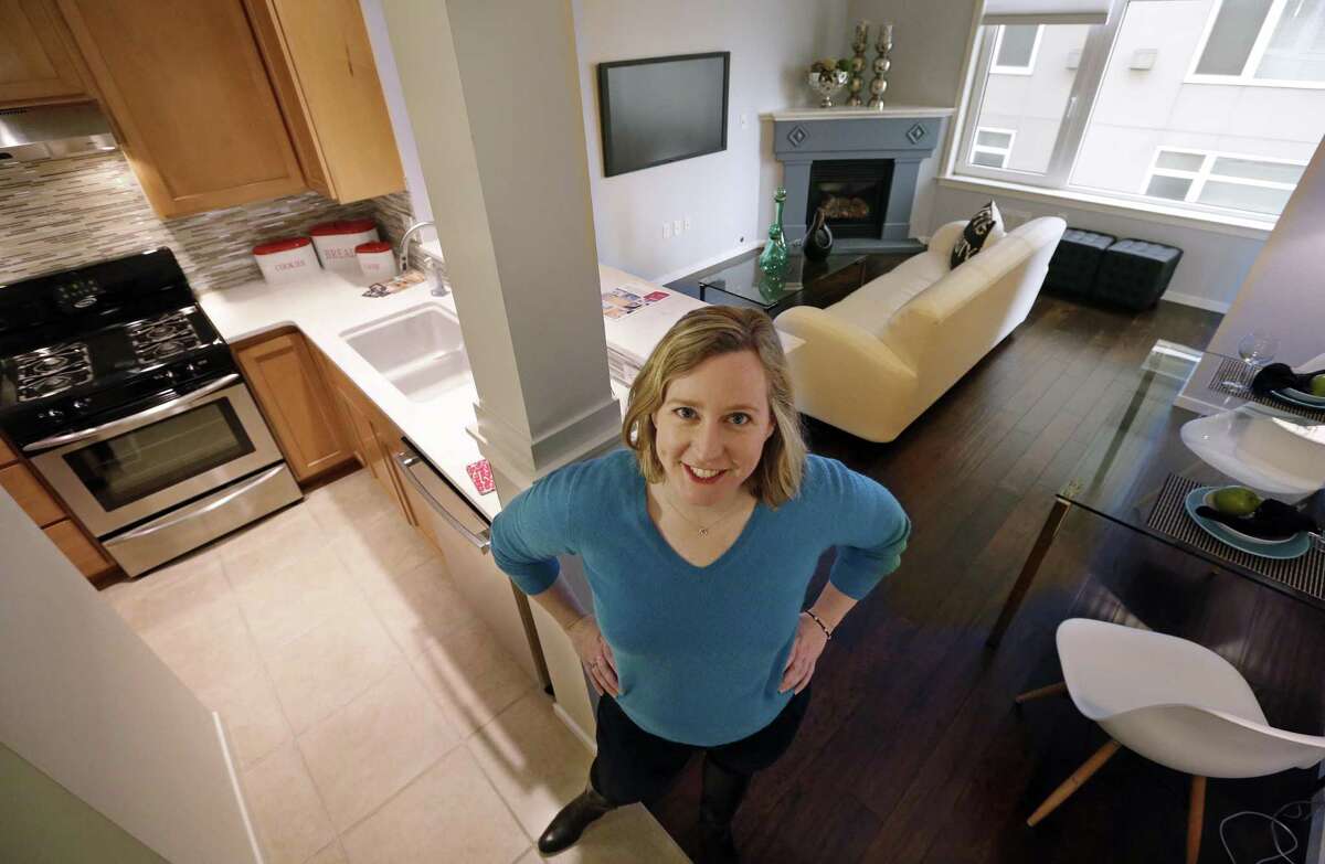 Kathleen Mulcahy stands in her recently sold one-bedroom condo, on which she received nearly two dozen offers and sold for more than $100,00 over her asking price, in Seattle’s Belltown neighborhood.