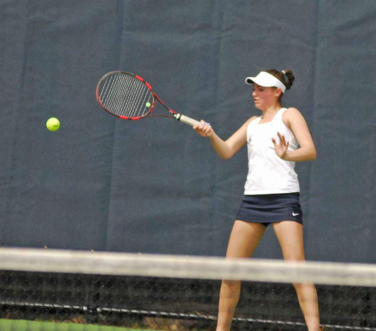 Staples' Alyssa DiMaio hits a shot during a match against Wilton on Monday.