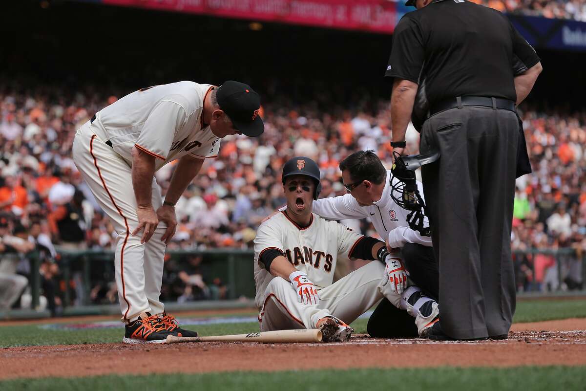 Giants' Buster Posey goes down after being hit by a pitch by Arizona's Taijuan Walker in the first inning, as the San Francisco Giants take on the Arizona Diamondbacks in their home opener against the at AT&T Park in San Francisco, Calif. on Mon. April 10, 2017.