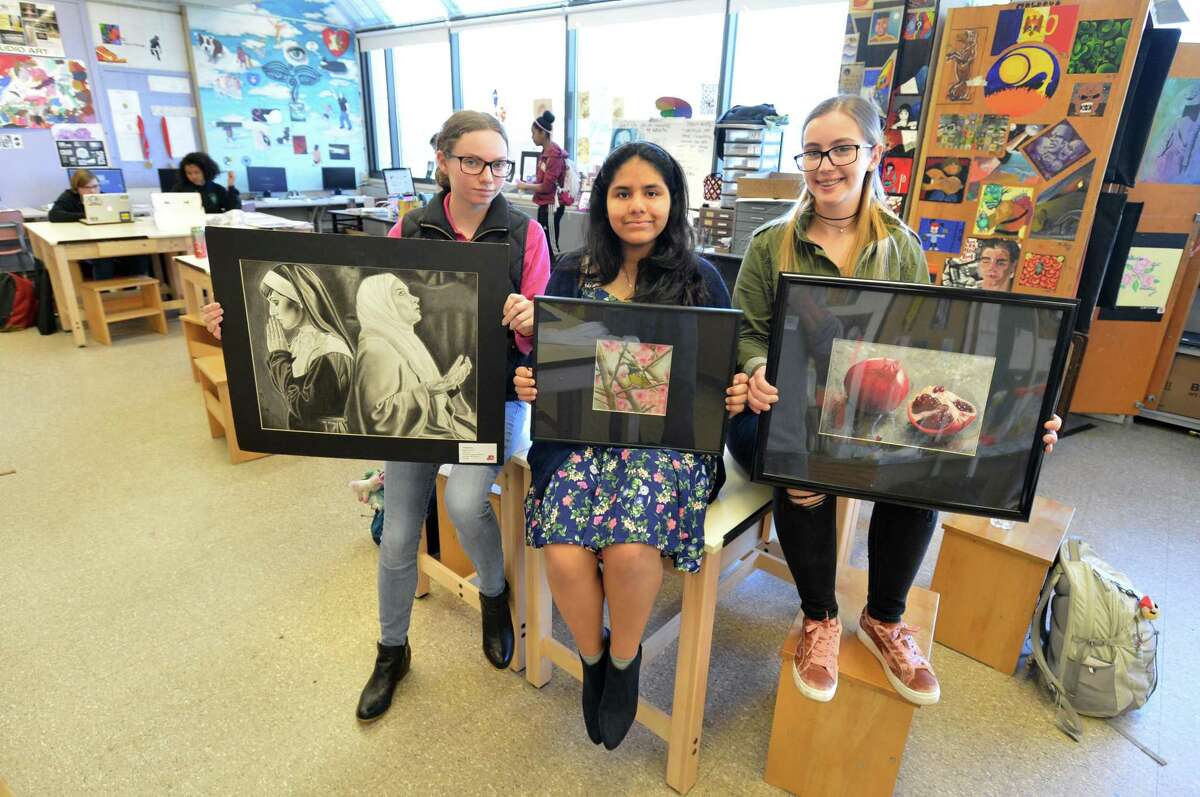 Norwalk High School students Megan Ruhnke, Kimberly Malaspina and Wiktoria Piktel win top prizes for their artwork in the annual Scholastic Art & Writing Awards. Showing their winning work in charcoal, mixed media and colored pencil in the art classroom at Norwalk High on Monday April 3, 2017 in Norwalk Conn.