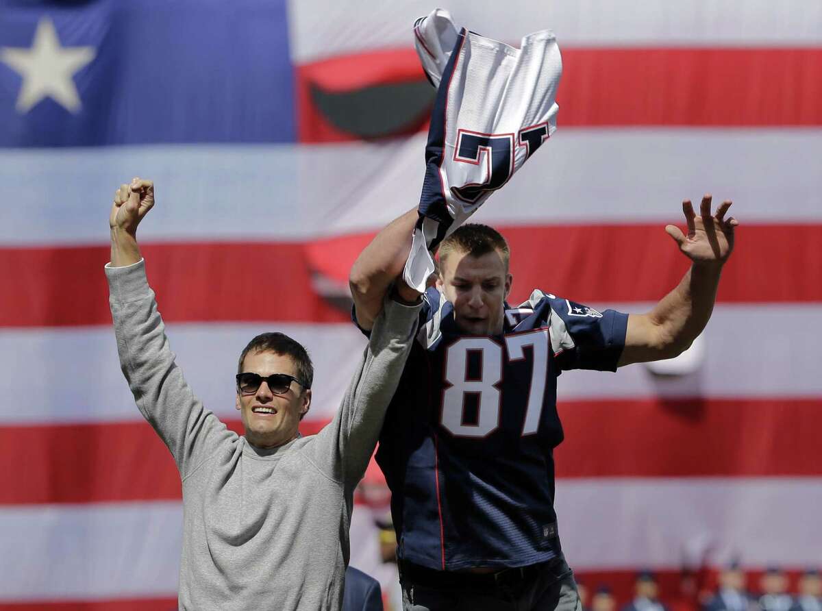Clowning around during the Boston Red Sox opening day, New England Patriots tight End Rob Gronkowski (right) swoops in to grab a stolen — then recovered — jersey from teammate Tom Brady. A reader is amazed that so much energy was expended to recover the Super Bowl jersey.