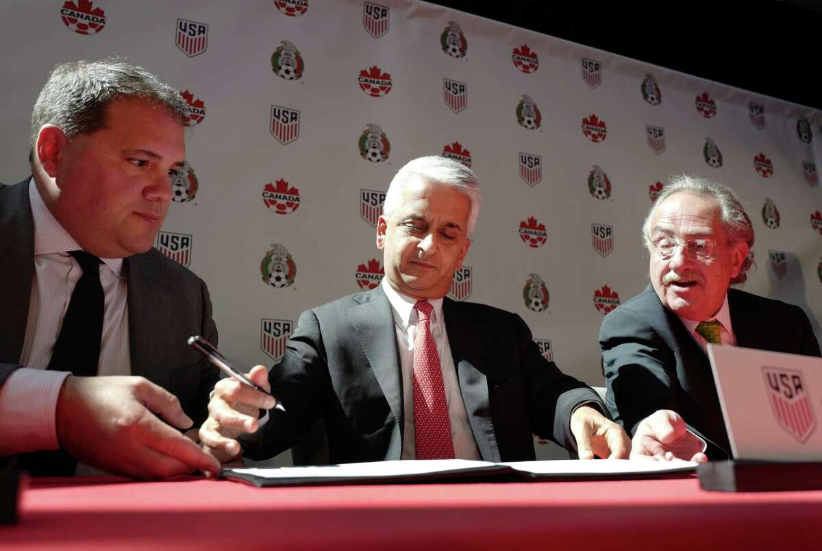 Victor Montagliani, left, President of the Canadian Soccer Association, Sunil Gulati, center, President of the United States Soccer Federation, and Decio de Maria, President of the Mexican Football Federation, sign the document of intent to FIFA seeking to co-host the 2026 World Cup, Monday, April 10, 2017, in New York. (AP Photo/Mark Lennihan)