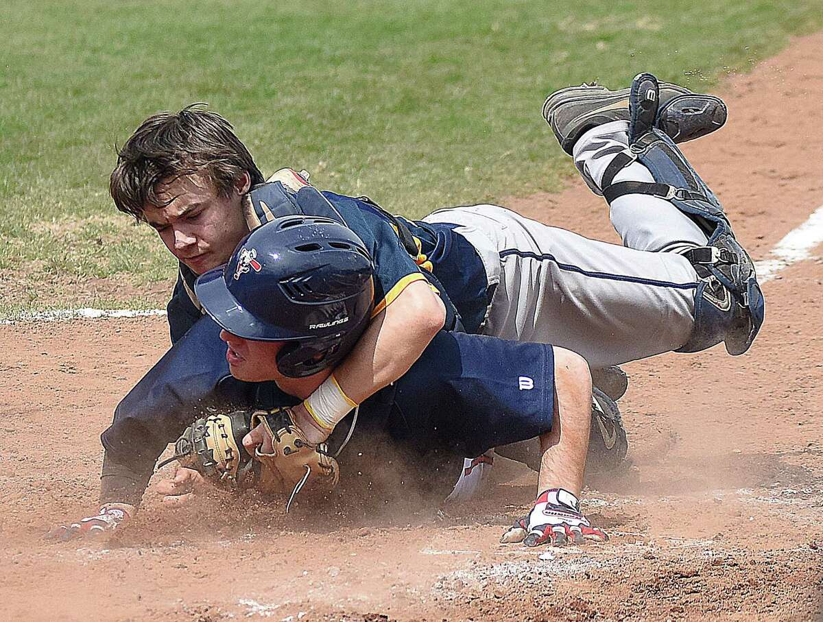 Weston catcher Jake Cavicchia, top, gets tangled up with McMahon baserunner Ari Lander on a play at the plate during Monday's non-conference baseball game at Revson Field in Weston. Lander was out on the play, but the Senators went on to post a 9-2 win.
