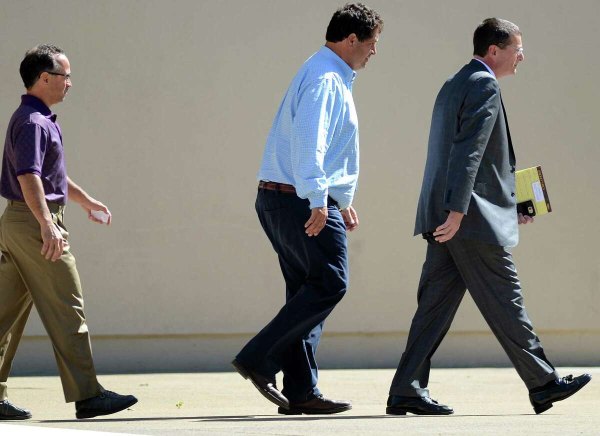 Joseph Gerardi, left, and Steven Aiello, center, both of COR Development Co., walk from the Federal Building in downtown Syracuse, N.Y., Thursday, Sept. 22, 2016. The men face federal corruption charges in U.S. Attorney Preet Bharara's investigation into economic development projects in Upstate New York. Aiello and Gerardi are accused of bribing a former top aide to Gov. Andrew Cuomo. Michael Greenlar /The Syracuse Newspapers via AP)