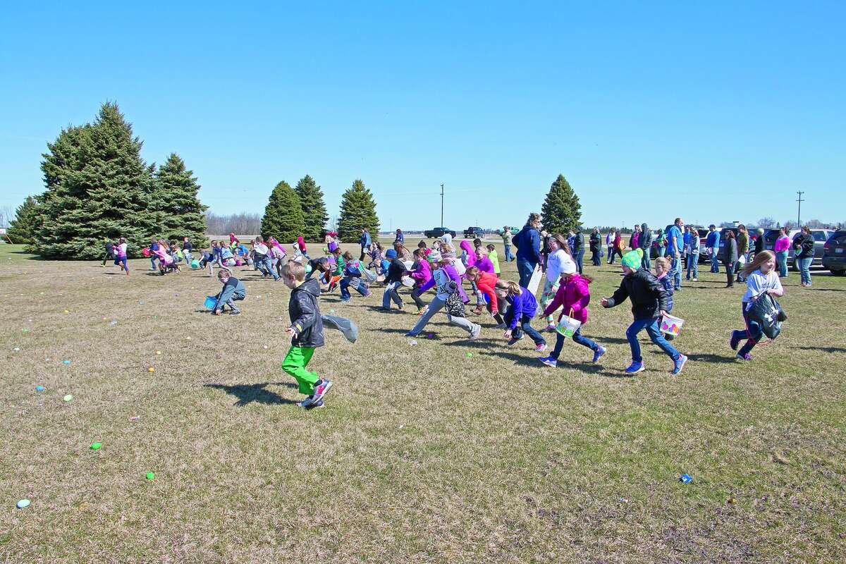 An avid group of 7- to 9-year-olds run for eggs at one of the hunts hosted Saturday by the Bad Axe Free Methodist Church.