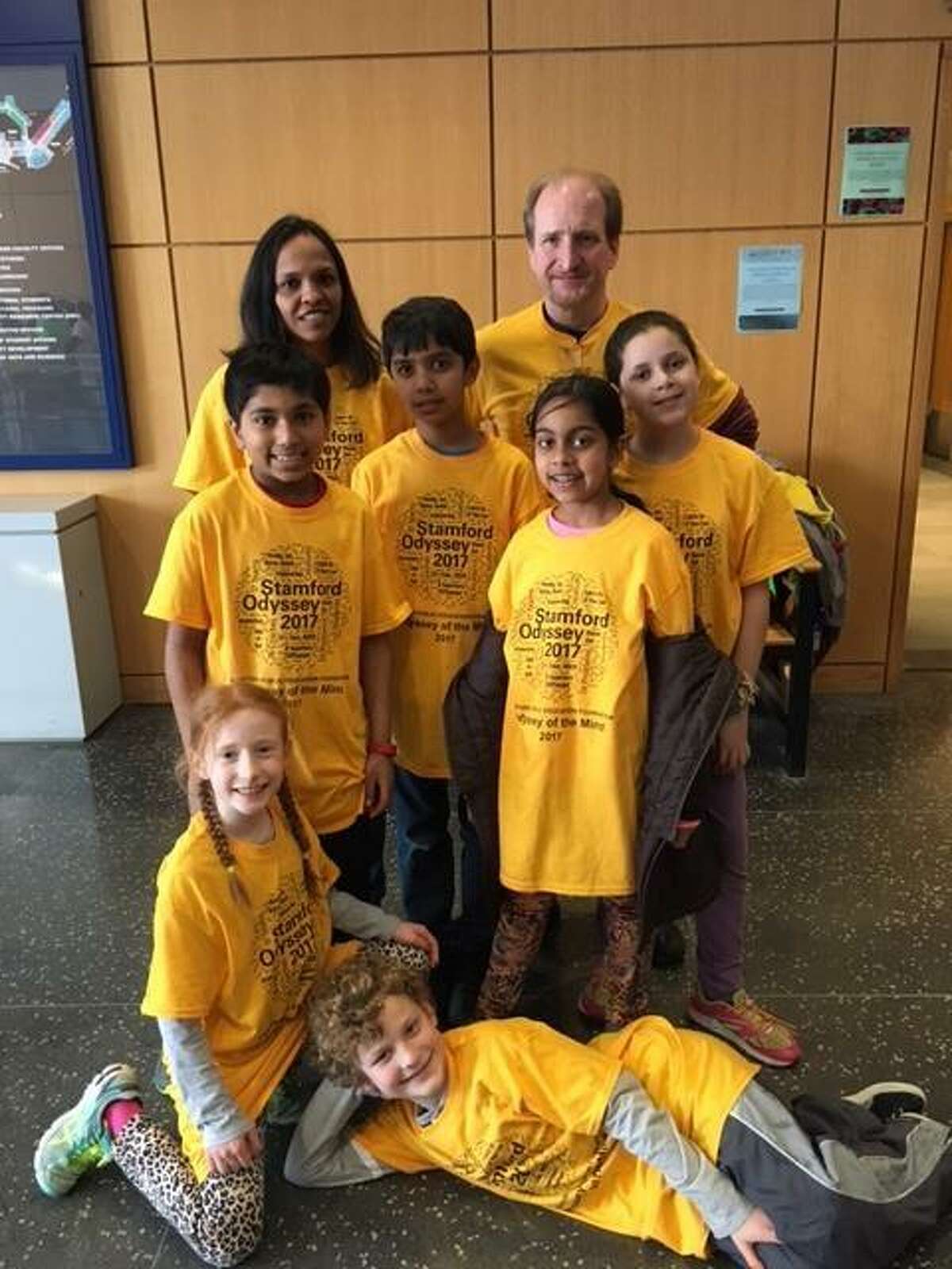 From left, coaches Rajni Chidambaram and Glenn Harper pose for a picture with Newfield Elementary School students Veeraj Shah Sidhanth Pharshy, Ananya Gupta and Riley Allyn in the second row and Alanna Harper and Wyatt Elsner in the front row during the Odyssey of the Mind statewide tournament at Southern Connecticut State University in New Haven, Conn., on March 18, 2017.