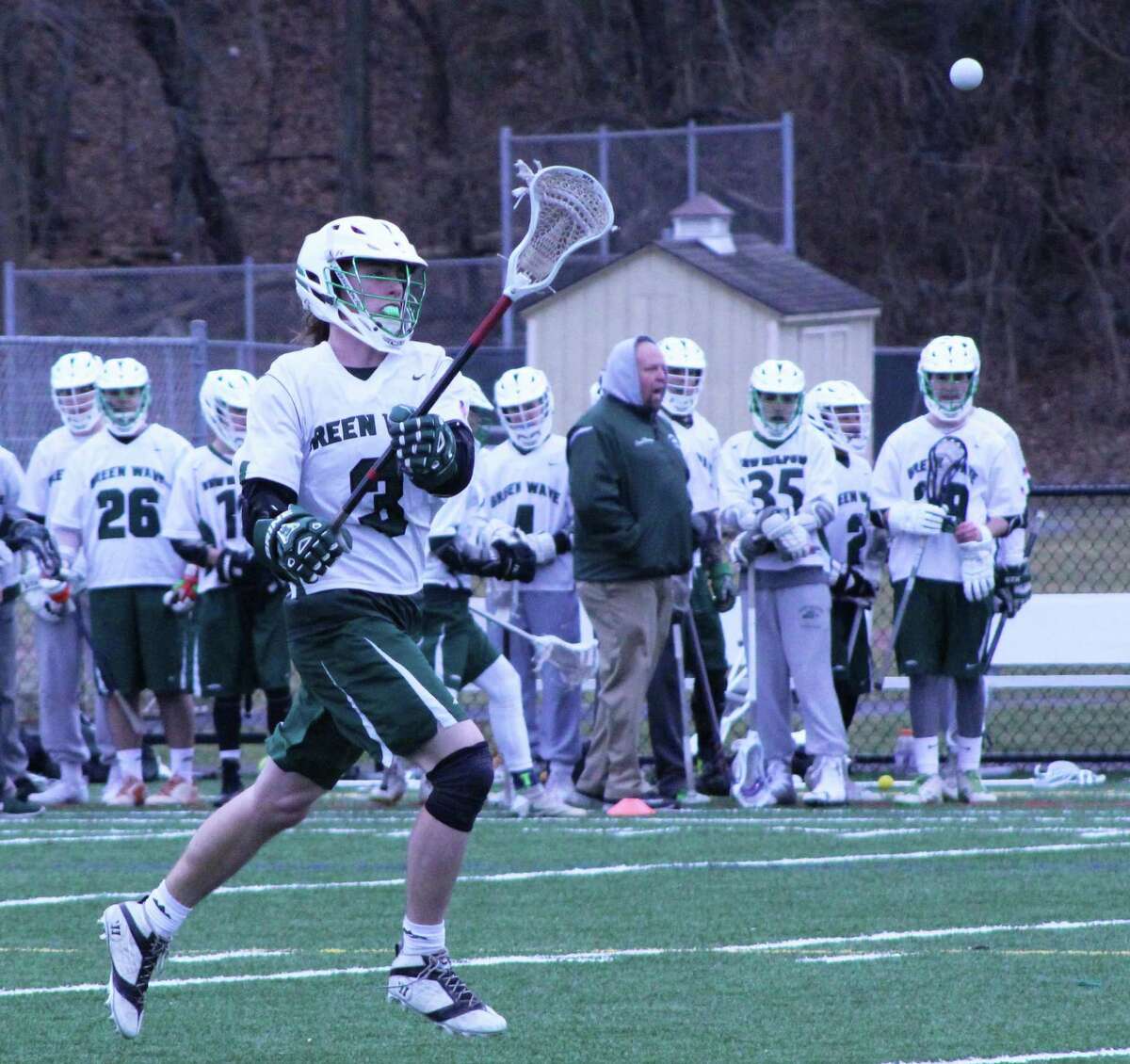 The New Milford High School boys’ lacrosse team recently played Pomperaug High School. The Green Wave won their first game of the season with a score of 8-6. Junior Nate Capriglione throws the ball to a teammate on the field during the April 1 game.