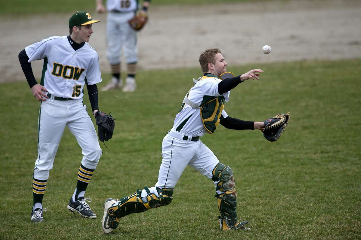 BRITTNEY LOHMILLER | blohmiller@mdn.net Dow High's Michael Ericson grabs Meridian's Garrett Stockford's bunt and throws to first baseman Jake Lapham in the first inning of the Tuesday afternoon game.