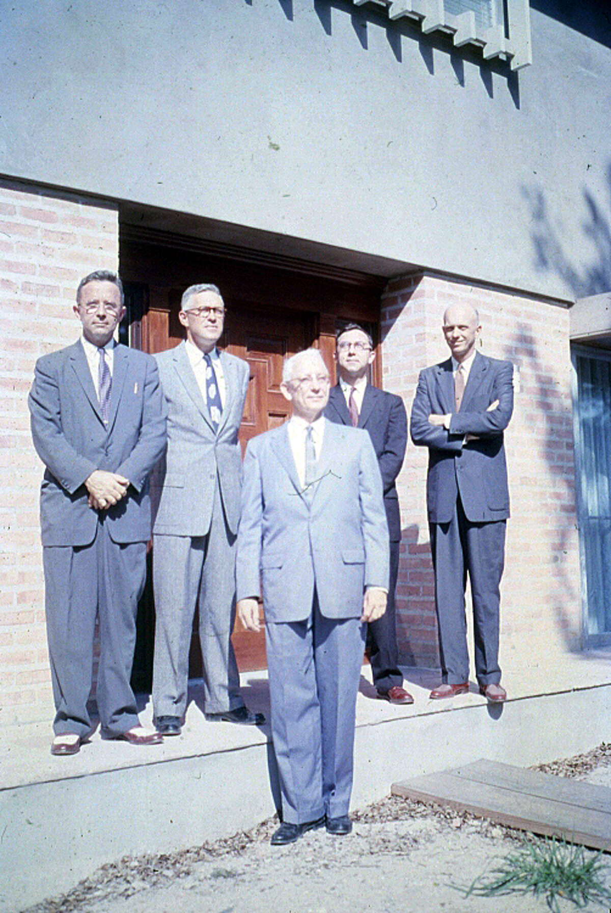 The masters of Rice's then five colleges, standing just outside the entrance to a campus building in 1957.