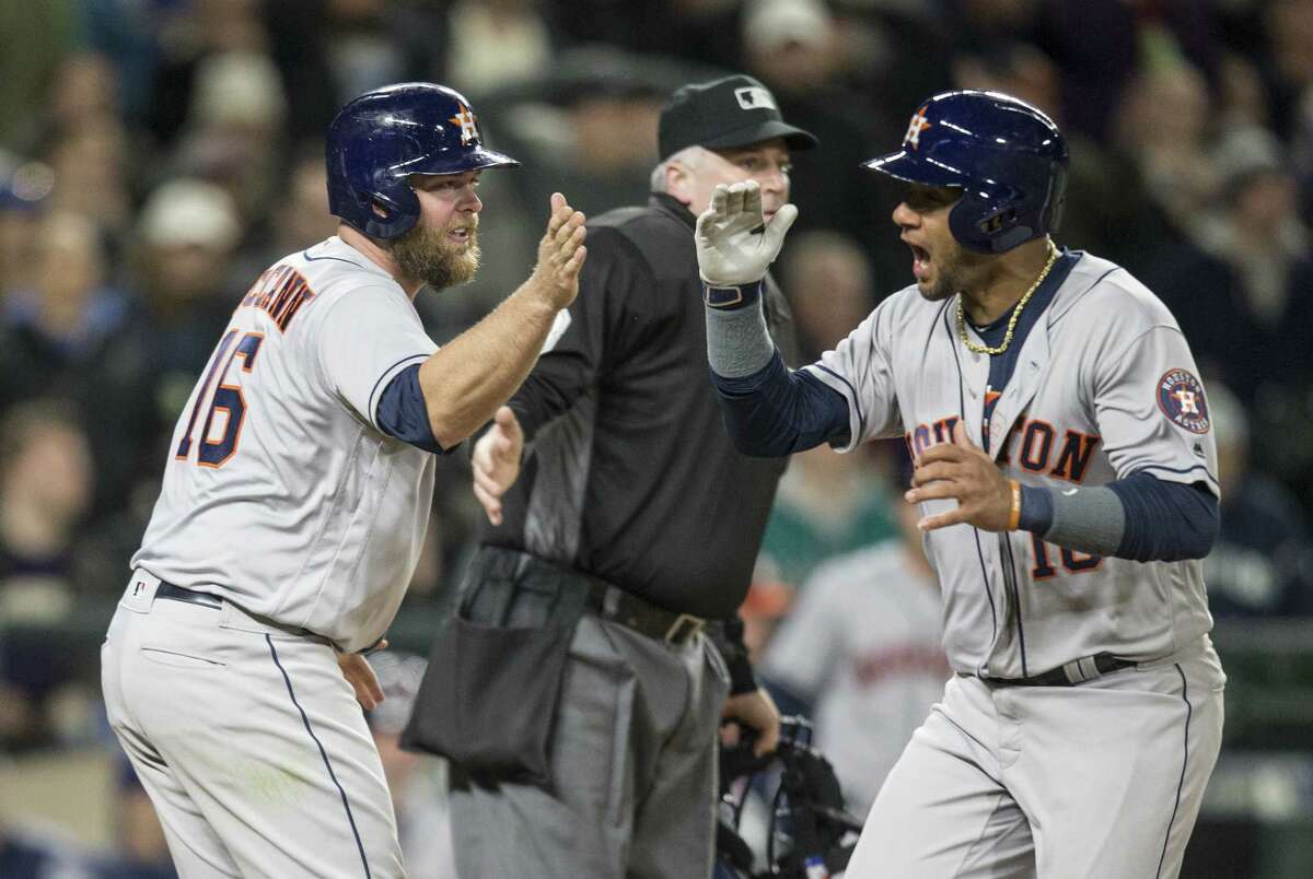 SEATTLE, WA - APRIL 11: Brian McCann #16, left, of the Houston Astros congratulates Yuli Gurriel #10 after McCann, Gurriel and Marwin Gonzalez #9 of the Houston Astros scored on a three-run double by Evan Gattis #11 of the Houston Astros off of relief pitcher James Pazos #47 of the Seattle Mariners during the sixth inning of a game at Safeco Field on April 11, 2017 in Seattle, Washington.