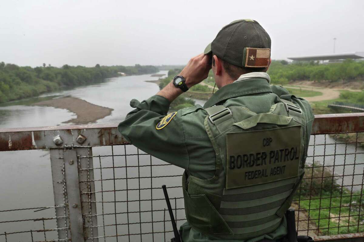 ROMA, TX - MARCH 13: A U.S. Border Patrol agent scans the U.S.-Mexico border while on a bridge over the Rio Grande on March 13, 2017 in Roma, Texas. The Border Patrol has reported that illegal crossings from Mexico have dropped some 40 percent along the southwest border since Donald Trump took office.