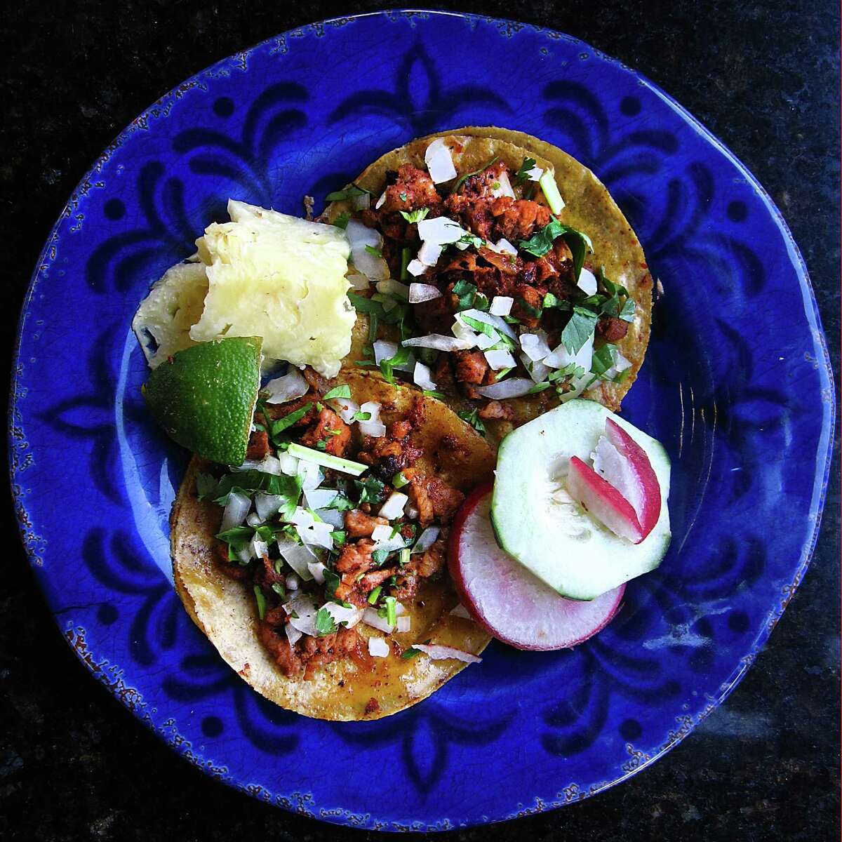 Taco of the Week: Al pastor tacos with pineapple, lime, radishes, cucumber, cilantro and onions from Taquitos West Ave.