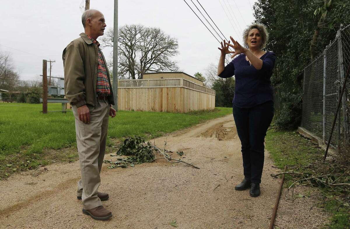 Oak Park Northwood Homeowners Association members Cynthia Franklin (right) and John Whitsett chat near the Google Hut in Haskin Park on Wednesday, Jan. 4, 2017. They are disappointed by the location of the Google Hut which was placed in Haskin Park. Franklin used to be able to look past her chain-link fence and see her kids playing on a playscape in the little park. Now, however, the hut blocks her view. She and Whitsett are upset and say the city violated its own ordinances in allowing Google to install the network building there. Among other things, they say, it violates rules about fencing, noise and construction. (Kin Man Hui/San Antonio Express-News)