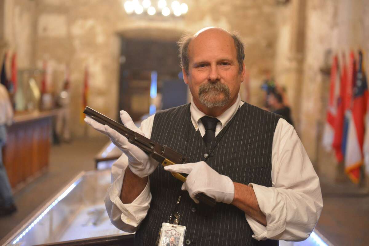 Alamo historian and curator Bruce Winders holds a Colt Walker pistol, which was designed for use by the Texas Rangers by Samuel Colt and Rangers Capt. Samuel Hamilton Walker.