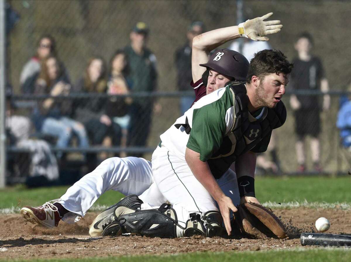 Bethel's Tyler Davis (2) slides across home plate for a run while New Milford catcher Derek Profita (9) waits for the throw in the boys baseball game between Bethel and New Milford high schools. Wednesday, April 12, 2017, at New Milford High School, New Milford, Conn. New Milford beat Bethel 6-5.