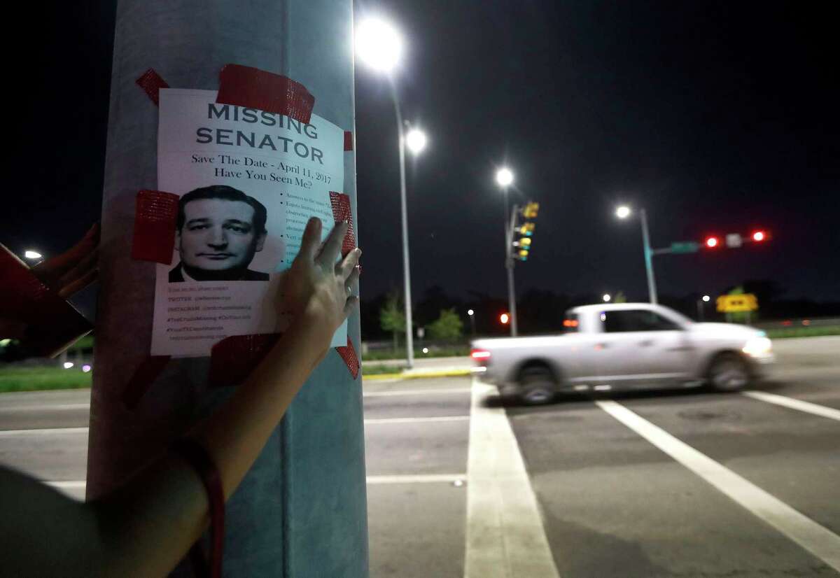 Using signature red duct tape, Houstonians put up "Ted Cruz is missing" fliers up around a Montrose neighborhood, Wednesday, March 29, 2017, in Houston. The fliers are catching people's attention, ahead of an upcoming "Ted Cruz Is Missing" town hall meeting. Originally scheduled for April 11, the town hall has now been moved to Saturday, April 15. ( Karen Warren / Houston Chronicle )