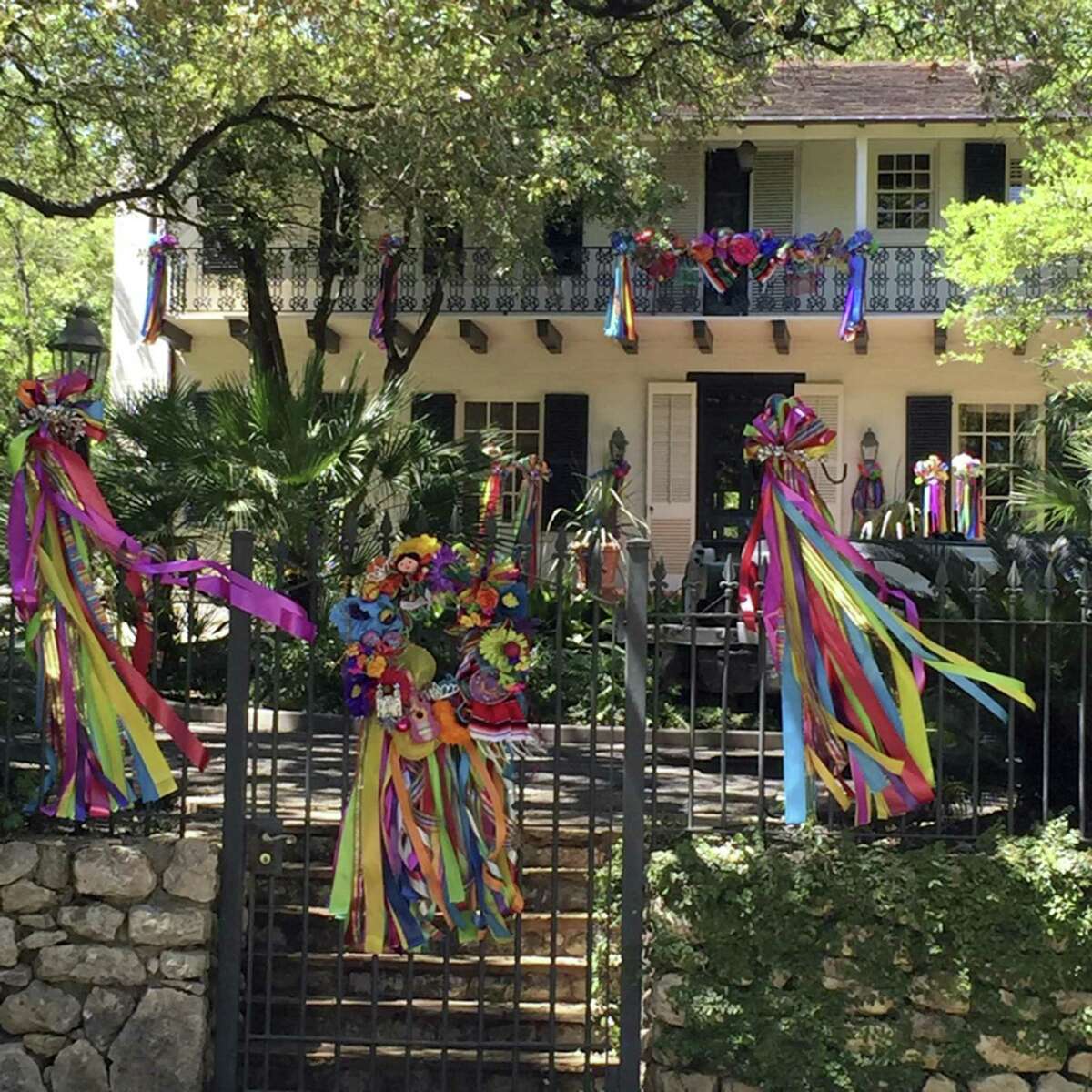 Spring breezes blow colorful Fiesta streamers to and fro from the garlanded balcony to the wrought iron gate posts.