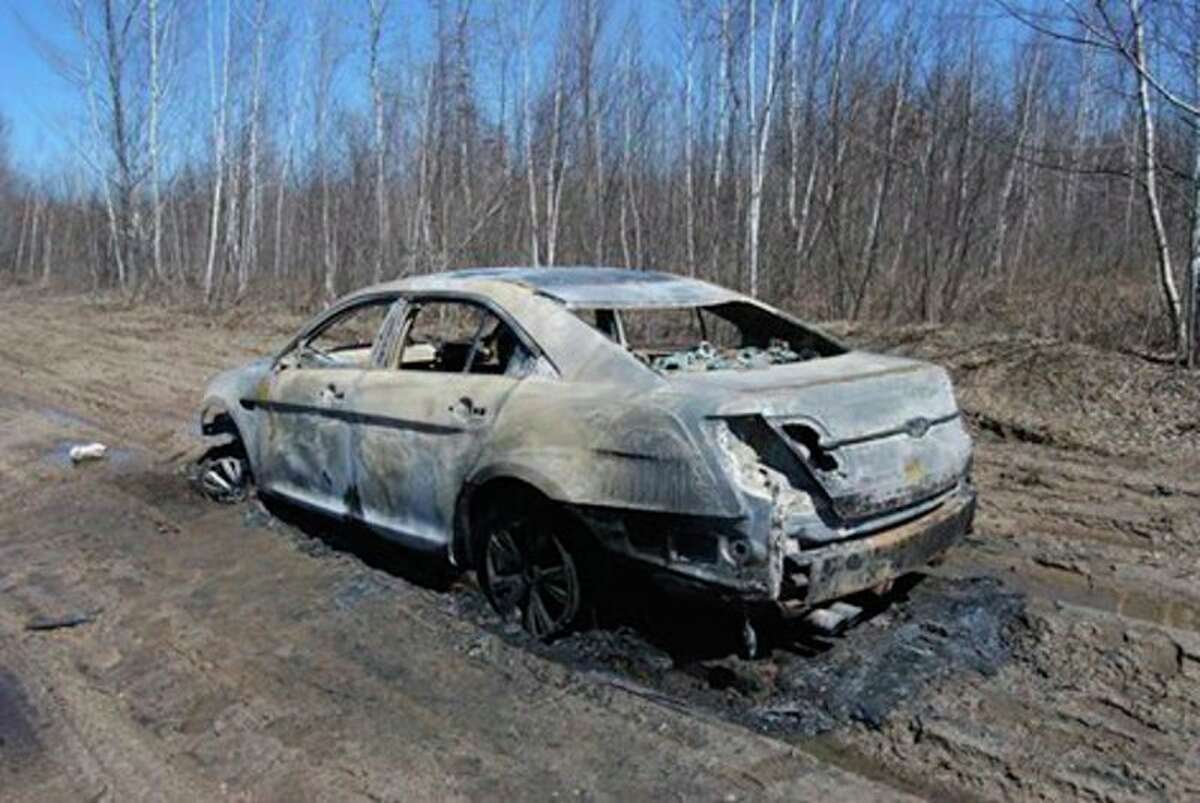 The 2011 Ford Taurus with human remains inside was found in the middle of a seasonal road in the Lame Duck Wildlife Area in Gladwin County's Bourret Township on April 7. Photo provided by the Gladwin County Sheriff's Office.