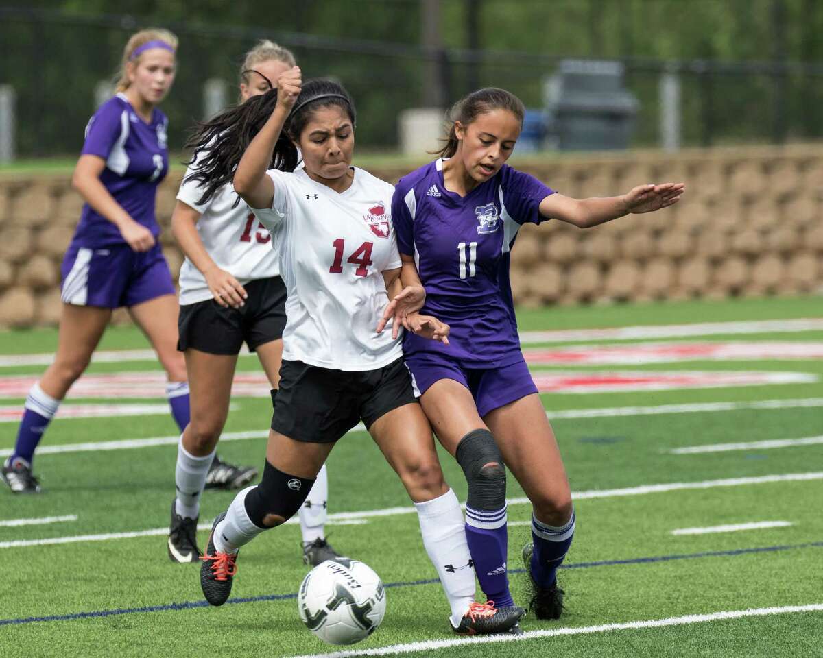 Jasper Bulldogs Salma Segovia (14) battles Boerne Greyhounds Brianna Barrera (11) for possession during the Class 4A UIL girls soccer state semifinal game between the Jasper Bulldogs and the Boerne Greyhounds at Birkelbach Field in Georgetown, Texas, on April 12, 2017. Boerne won 2-1.