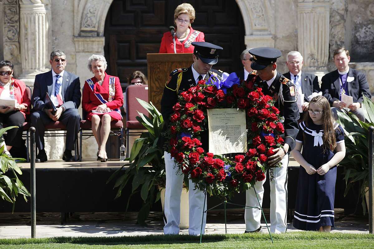 Members of the Texas Military Institute JROTC, Cadet Lt. Col. James Atkins (left) and Cadet 1st. Lt. Isaac Sandoval, carry a wreath with a copy of the Texas Declaration of Independence during a celebration in front of the Alamo in 2011. The Alamo Mission Chapter of the Daughters of the Republic of Texas honored educators and students of Texas History as part of Texas' 175th anniversary of independence.